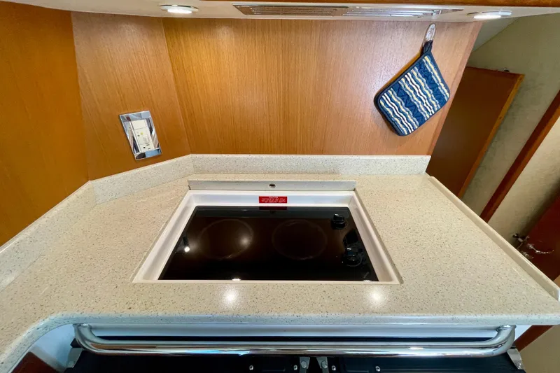 Slide: The Image of 2006 Cabo 40 Flybridge kitchen with sleek cooktop and modern design. - 30