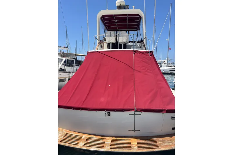 Slide: The Image of Cockpit of 1980 Golden Egg 48 Sport Fish boat with navigation instruments and marina view. - 10