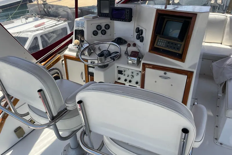 Slide: The Image of Two cushioned captain's chairs on a 1980 Golden Egg 48 Sport Fish boat deck. - 13