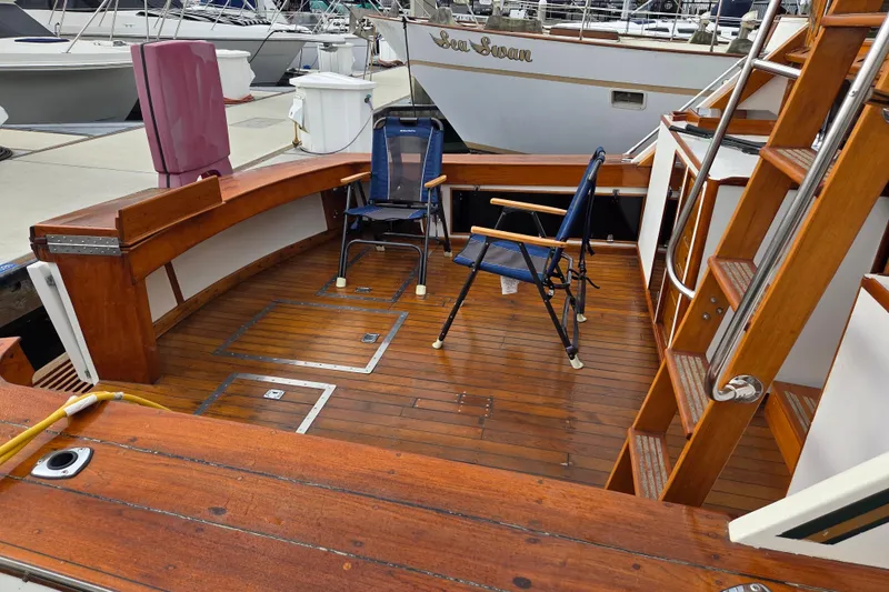 Slide: The Image of Woman arranging flowers on 1980 Egg Harbor 52 Convertible yacht deck, docked at marina. - 19