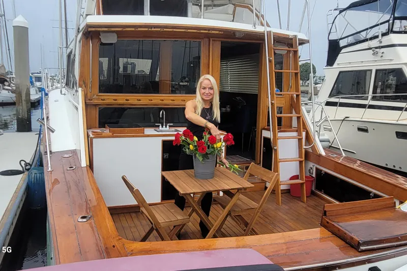 Slide: The Image of 1980 Egg Harbor 52 Convertible yacht helm with wooden cabinetry and steering wheel. - 20