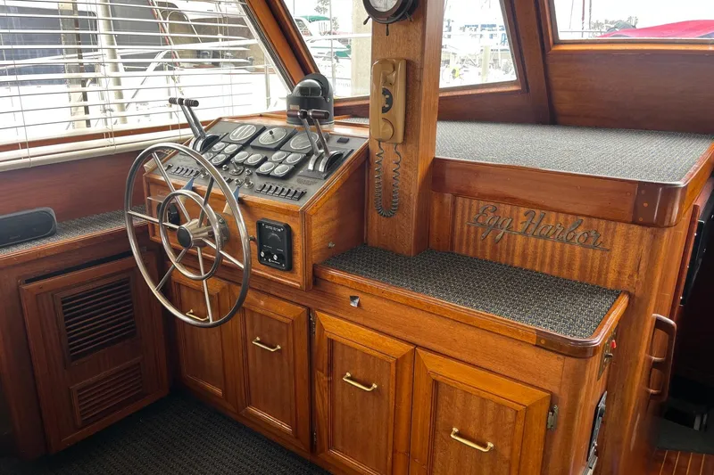 Slide: The Image of Control panel of a 1980 Egg Harbor 52 Convertible boat with gauges and levers. - 21