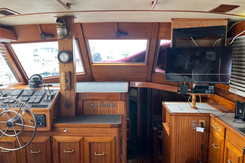 Slide: The Image of Interior of a 1980 Egg Harbor 52 Convertible yacht with cozy seating and nautical decor. - 24