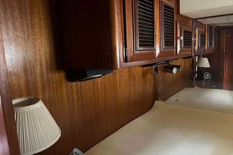 Slide: The Image of Interior cabin of 1980 Egg Harbor 52 Convertible yacht with wooden finishes. - 30