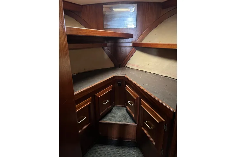 Slide: The Image of 1980 Egg Harbor 52 Convertible yacht bathroom with sink, mirror, and wooden cabinetry. - 32