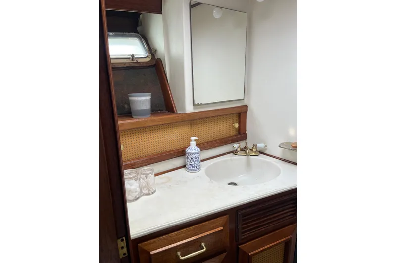Slide: The Image of 1980 Egg Harbor 52 Convertible yacht bathroom with wooden cabinets and sink. - 33