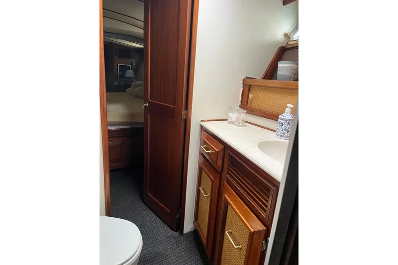 Slide: The Image of 1980 Egg Harbor 52 Convertible yacht bathroom with sink, mirror, and shower. - 34