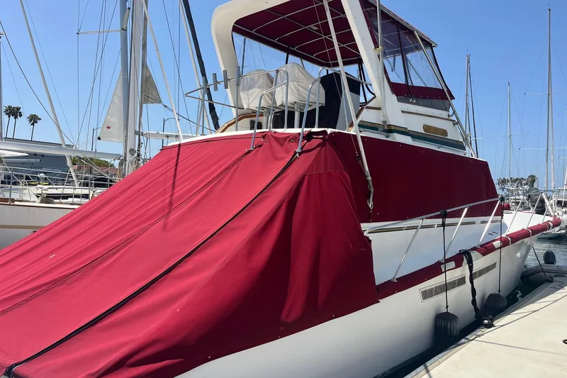 Slide: The Image of Bow view of 1980 Golden Egg 48 Sport Fish with red accents and anchor chain. - 4
