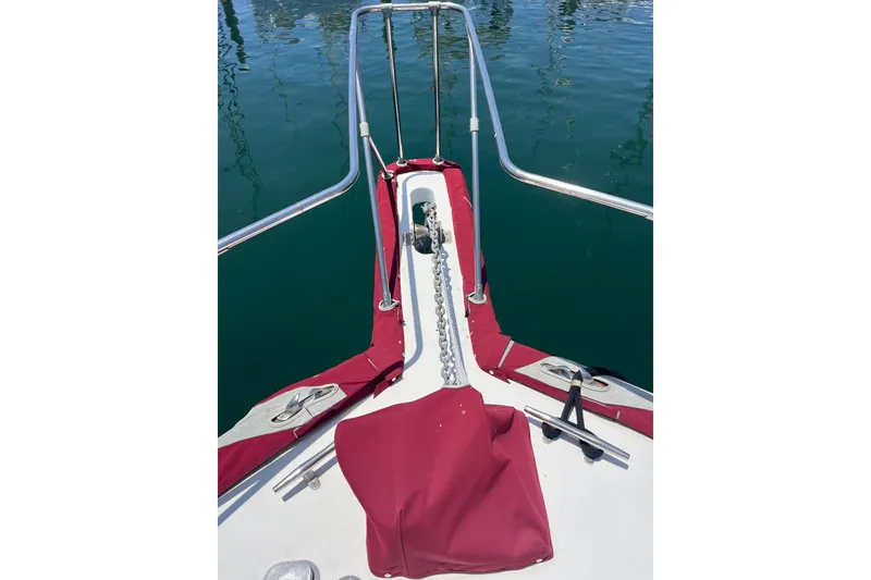 Slide: The Image of 1980 Golden Egg 48 Sport Fish boat deck with red covers, docked at marina. - 5