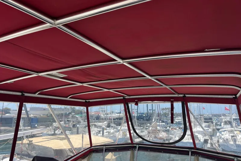 Slide: The Image of 1980 Golden Egg 48 Sport Fish boat with red cover docked at marina. - 9