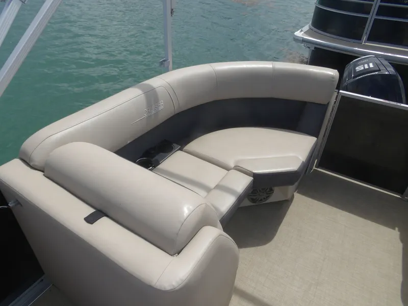 Slide: The Image of 2024 Harris Pontoon boat with beige seating area. - 12