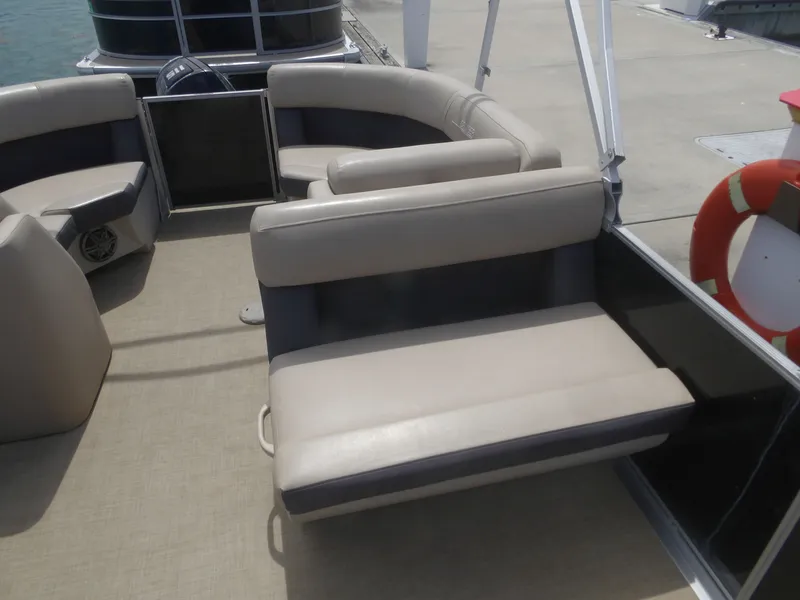 Slide: The Image of Interior of a 2024 Harris Pontoon boat with beige seating. - 14