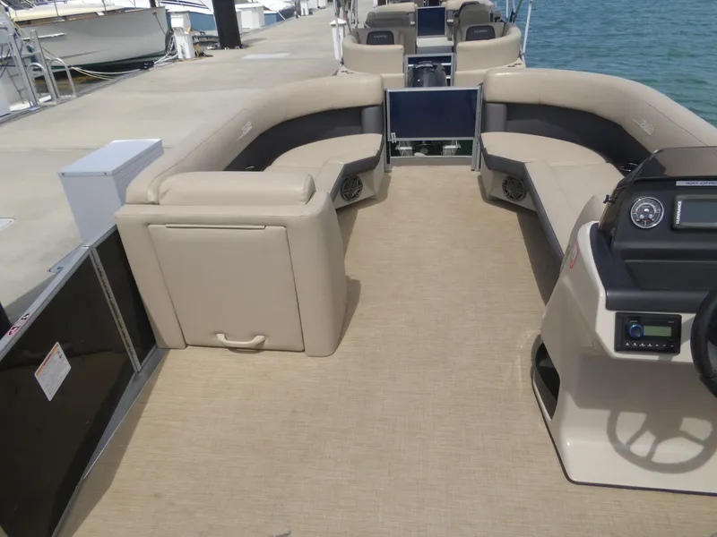 Slide: The Image of Interior of a 2024 Harris Pontoon boat with beige seating. - 19