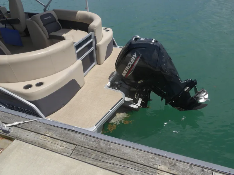 Slide: The Image of 2024 Harris Pontoon with Mercury outboard motor at dock. - 4