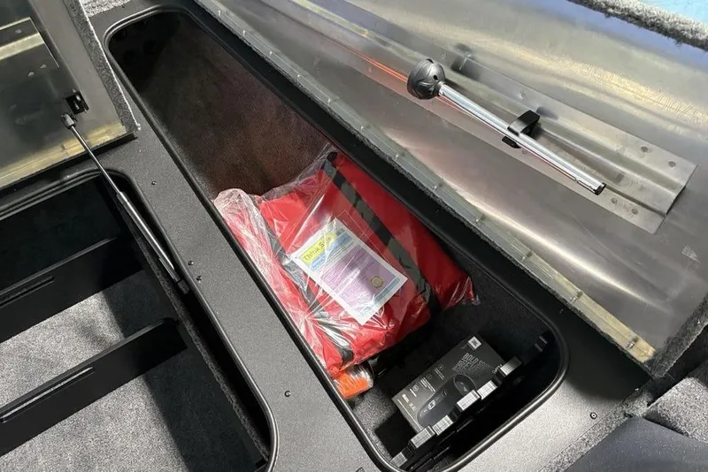 Slide: The Image of Storage compartment of 2026 Tracker Pro Team 190 boat with safety gear and equipment. - 15
