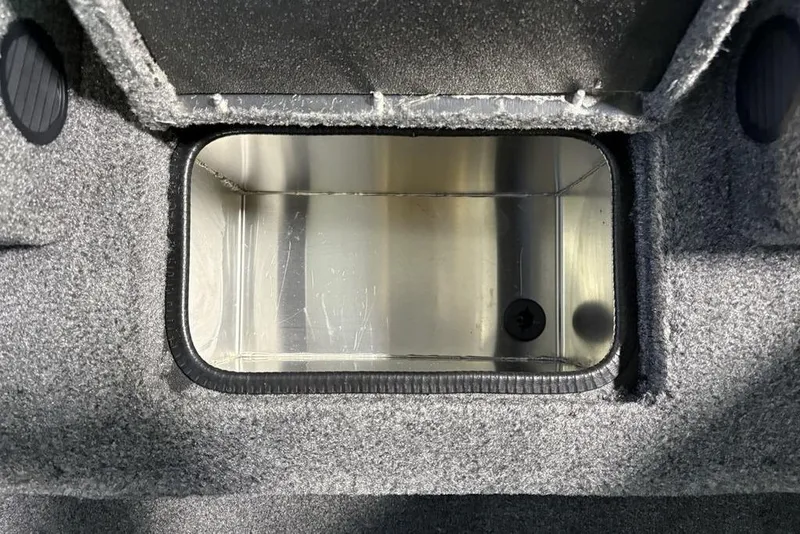 Slide: The Image of 2026 Tracker Pro Team 190 boat compartment with gray carpeted interior. - 16
