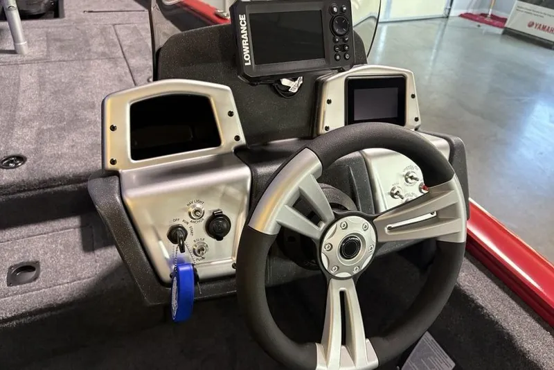 Slide: The Image of 2026 Tracker Pro Team 190 boat dashboard with steering wheel and navigation controls. - 18