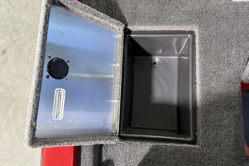 Slide: The Image of Open storage compartment in 2026 Tracker Pro Team 190 boat, featuring carpeted interior. - 27