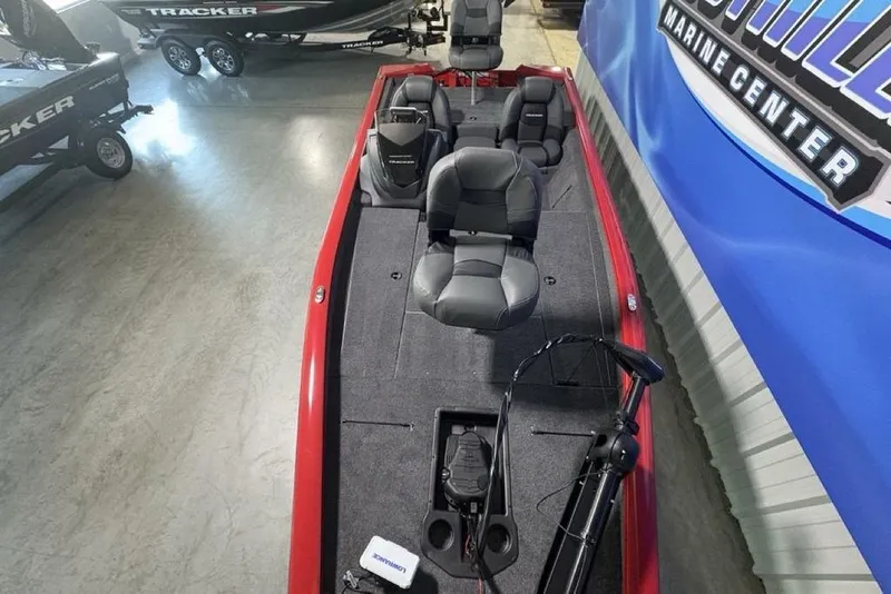 Slide: The Image of 2026 Tracker Pro Team 190 boat interior with seating and equipment in showroom. - 32
