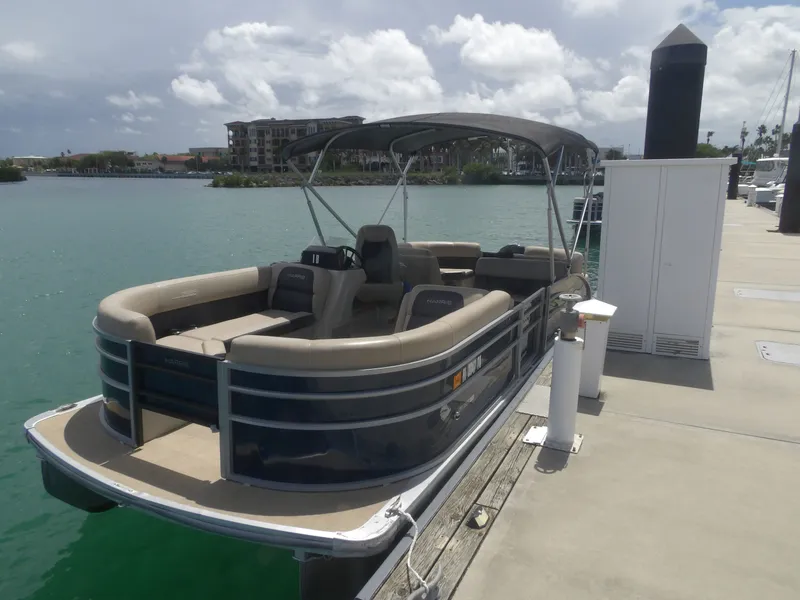 The Image of 2024 Harris Pontoon boat docked under sunny skies. - 0