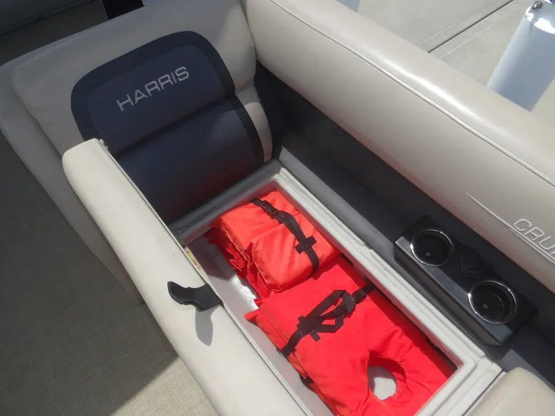 Slide: The Image of Harris Pontoon 2024 seat with life jackets and cup holders. - 11