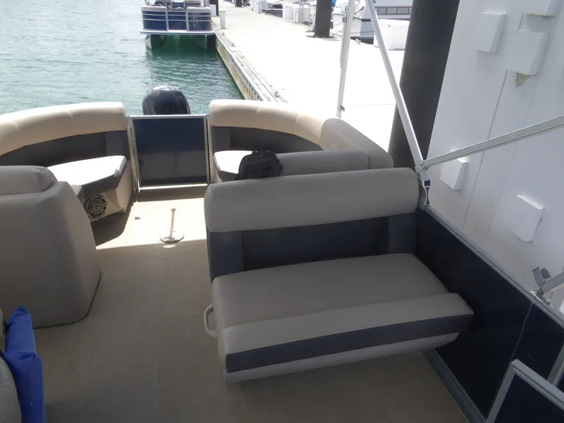 Slide: The Image of Interior of a 2024 Harris Pontoon boat at the dock. - 12