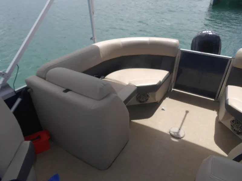 Slide: The Image of Interior of a 2024 Harris Pontoon boat with beige seating. - 13