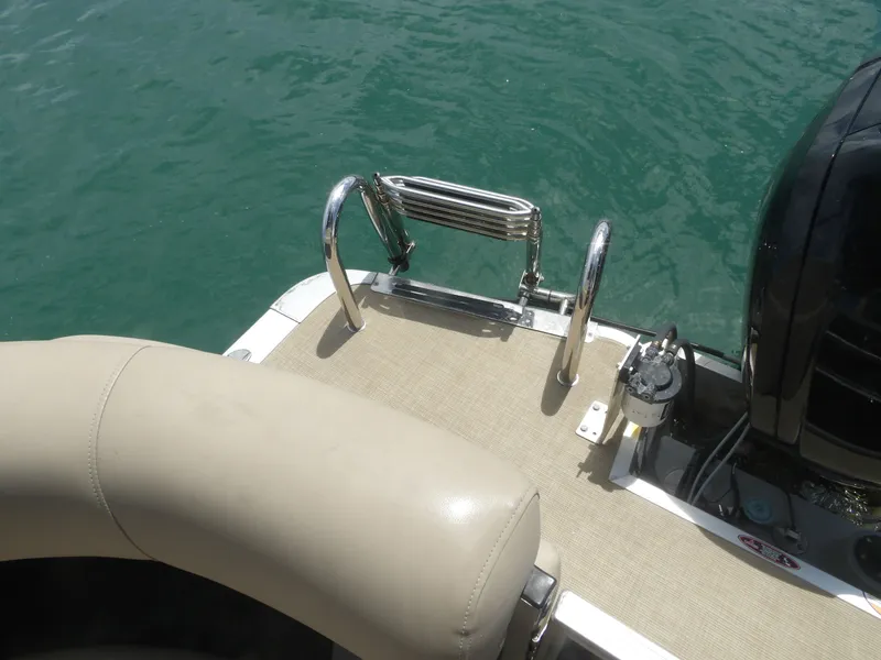 Slide: The Image of 2024 Harris Pontoon boat with ladder at the stern. - 16