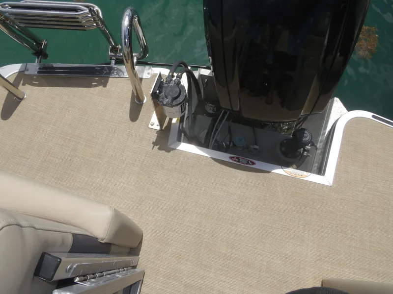 Slide: The Image of 2024 Harris Pontoon boat with motor and deck view. - 18