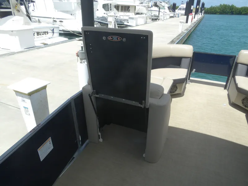Slide: The Image of 2024 Harris Pontoon boat with comfortable seating at the dock. - 26