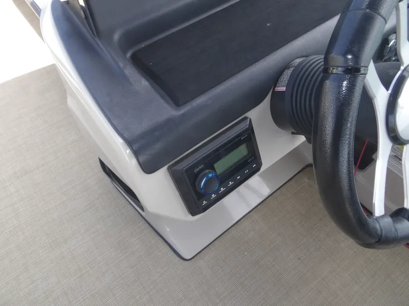Slide: The Image of 2024 Harris Pontoon steering console with wheel and control unit. - 28