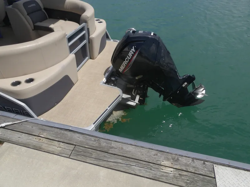Slide: The Image of 2024 Harris Pontoon with Mercury outboard motor at dock. - 30