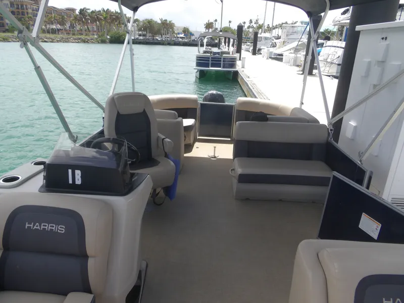 Slide: The Image of Interior of a 2024 Harris Pontoon boat docked at marina. - 5