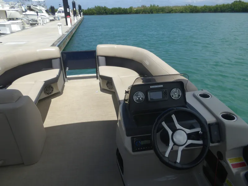 Slide: The Image of 2024 Harris Pontoon boat with modern cockpit and seating area. - 6