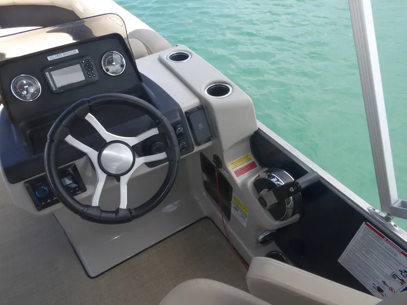 Slide: The Image of Steering console of a 2024 Harris Pontoon boat on water. - 8