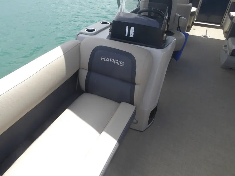 Slide: The Image of Interior of a 2024 Harris Pontoon boat with beige seating. - 9