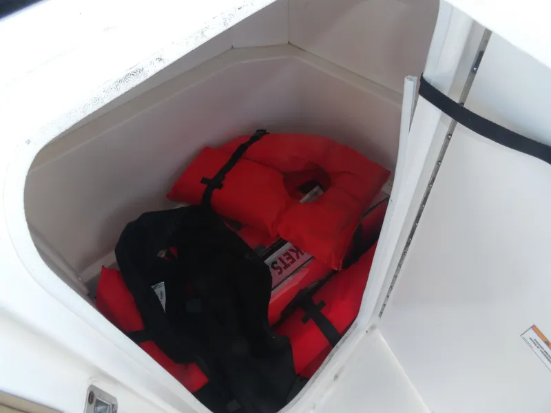 Slide: The Image of Storage compartment in Sea Ray SPX 230 boat with life jackets, 2024 model. - 13