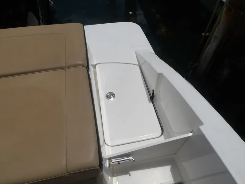 Slide: The Image of 2024 Sea Ray SPX 230 boat with seating area and storage. - 23