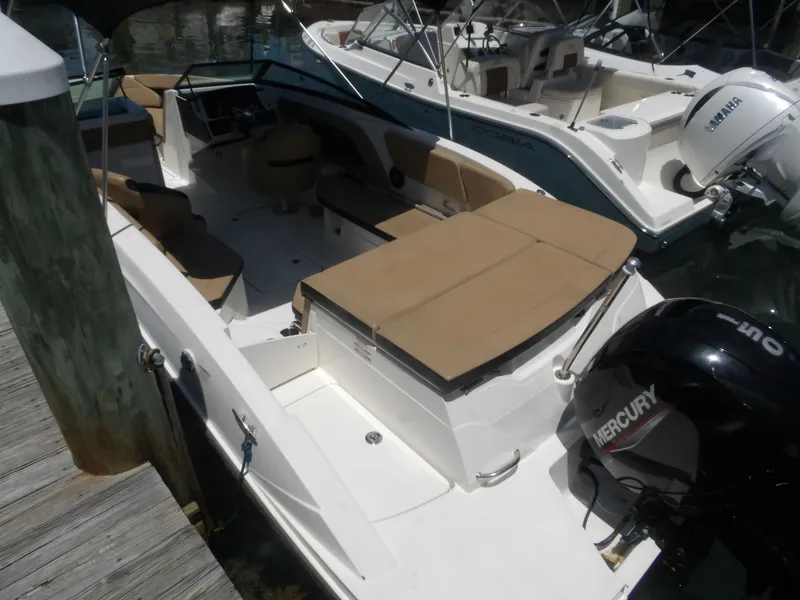 Slide: The Image of 2024 Sea Ray SPX 230 boat docked with Mercury engine. - 3