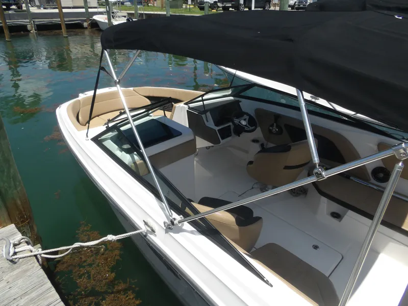 Slide: The Image of 2024 Sea Ray SPX 230 boat docked with black canopy. - 4
