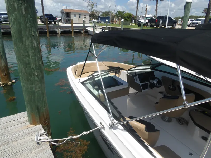 Slide: The Image of 2024 Sea Ray SPX 230 boat docked with black canopy. - 5