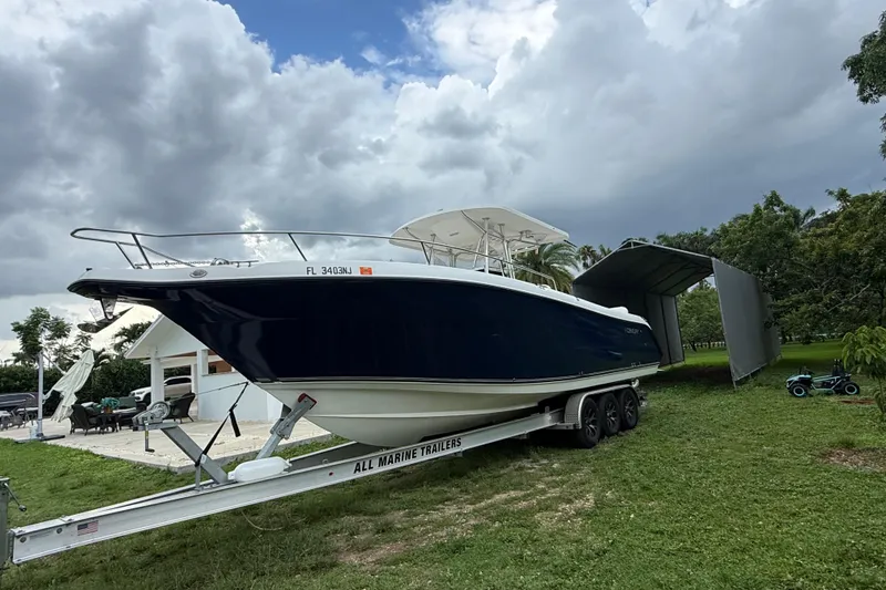 The Image of 2007 Century 3200 Center Console boat on trailer under cloudy sky. - 0