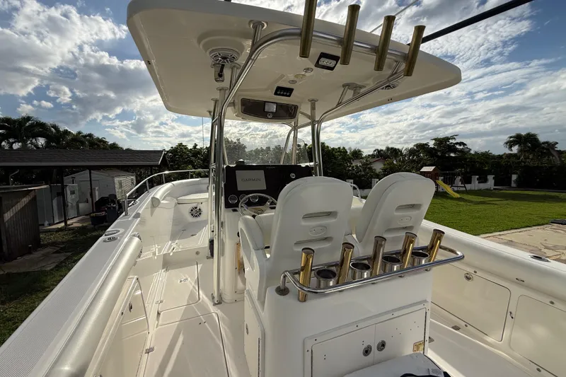 Slide: The Image of 2007 Century 3200 Center Console boat with dual seats and rod holders, under a cloudy sky. - 11