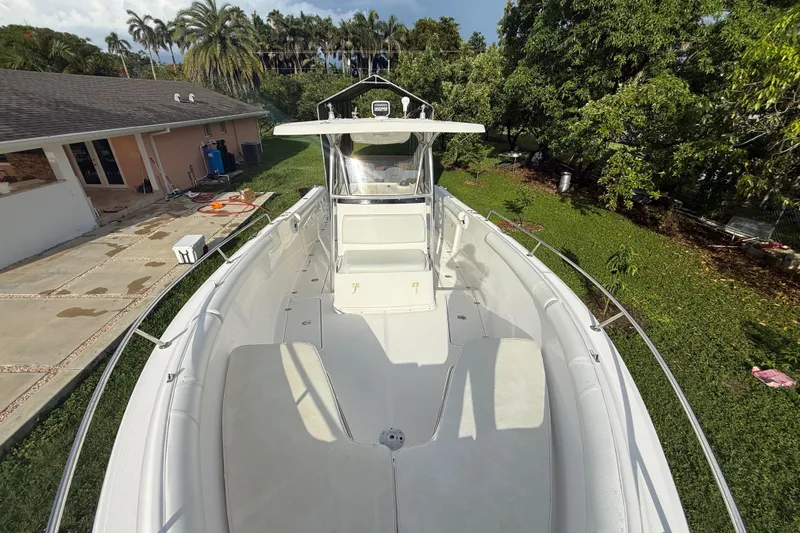 Slide: The Image of 2007 Century 3200 Center Console boat in a lush backyard setting. - 18
