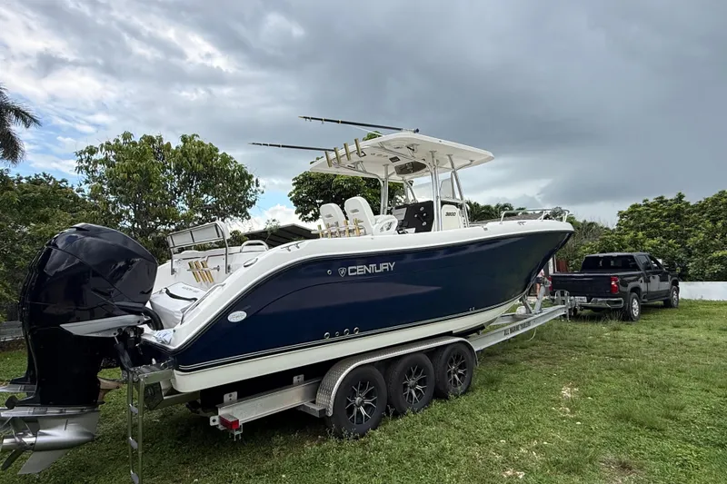 Slide: The Image of 2007 Century 3200 Center Console boat on trailer, parked outdoors with cloudy sky. - 2
