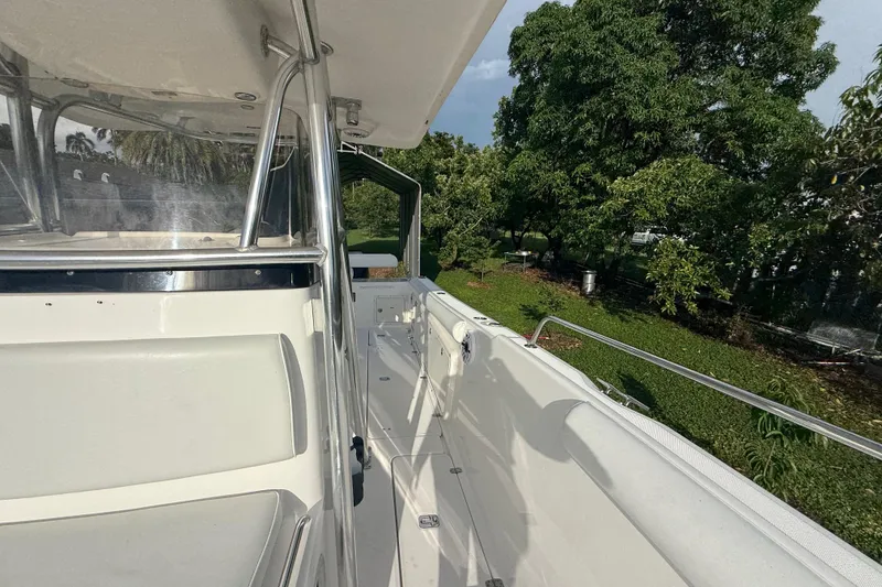 Slide: The Image of 2007 Century 3200 Center Console boat with sleek design, surrounded by lush greenery. - 22
