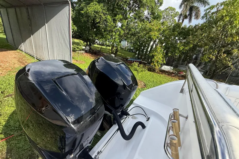 Slide: The Image of 2007 Century 3200 Center Console boat with dual outboard motors in a lush garden setting. - 24