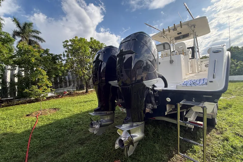 Slide: The Image of 2007 Century 3200 Center Console boat with dual outboard motors on grassy area. - 26