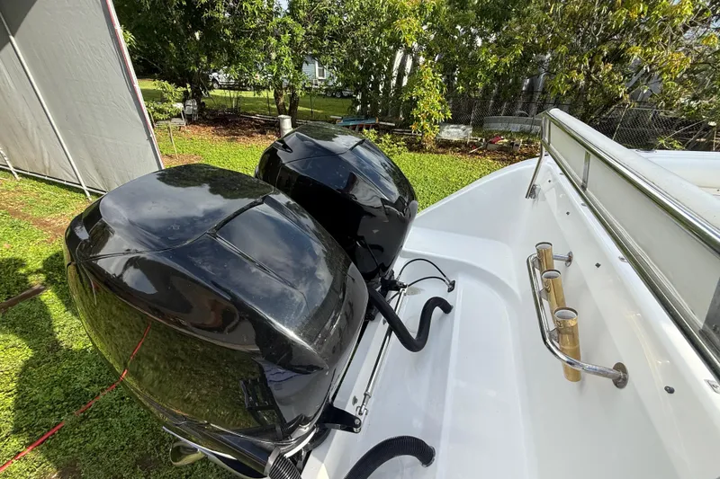 Slide: The Image of 2007 Century 3200 Center Console boat with dual outboard motors in a grassy yard. - 7