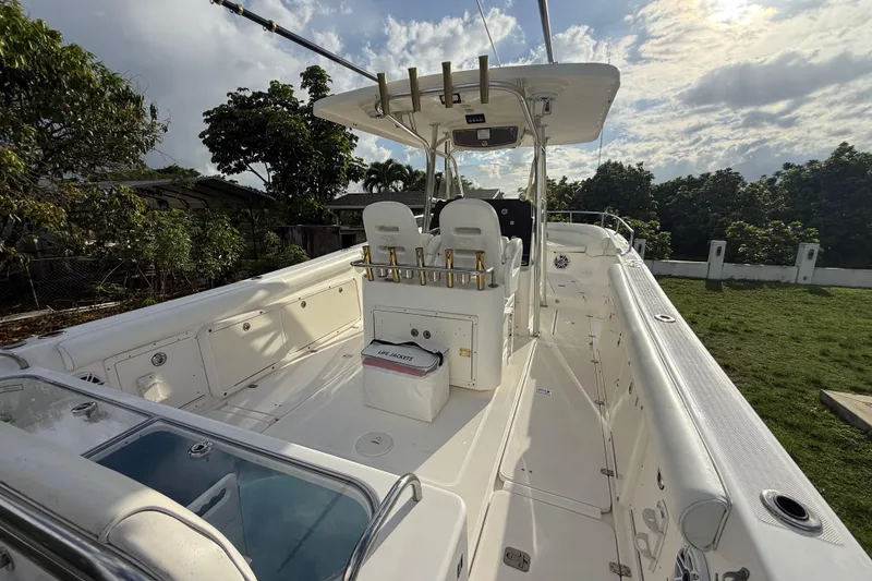 Slide: The Image of 2007 Century 3200 Center Console boat with spacious deck and fishing rod holders. - 8